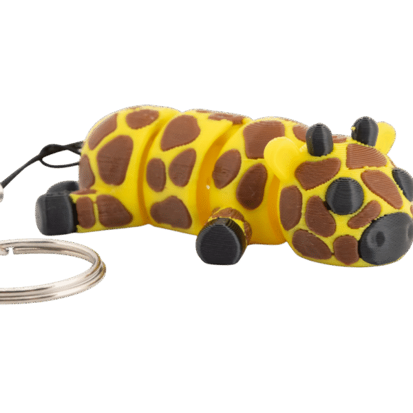Gigi – miniz brelok żyrafa z druku 3D w kolorze żółtym z brązowymi plamkami, przedstawiający leżącą żyrafkę z czarnym pyskiem i brelokiem.